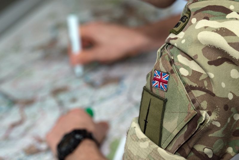 decorative image of a british soldier leaning over a map