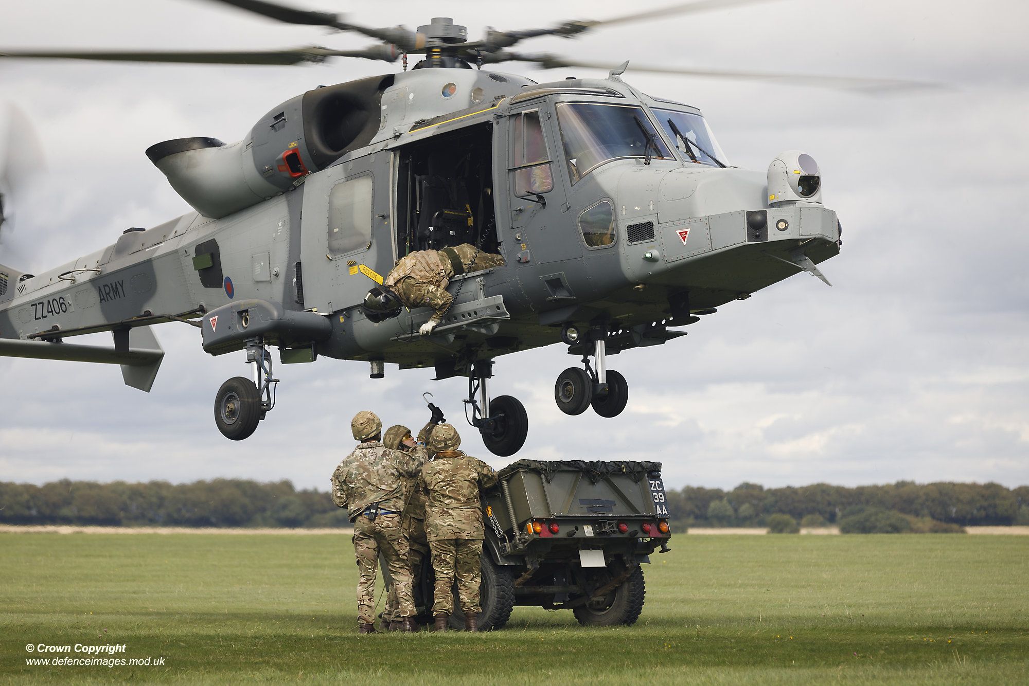 decorative image of servicemen passing supplies up to a helicopter