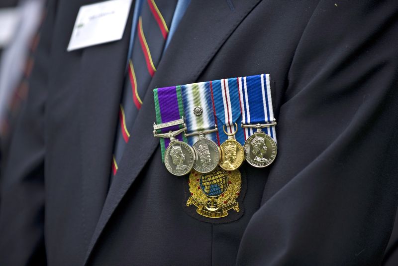 close up of veterans medals attached to a suit jacket